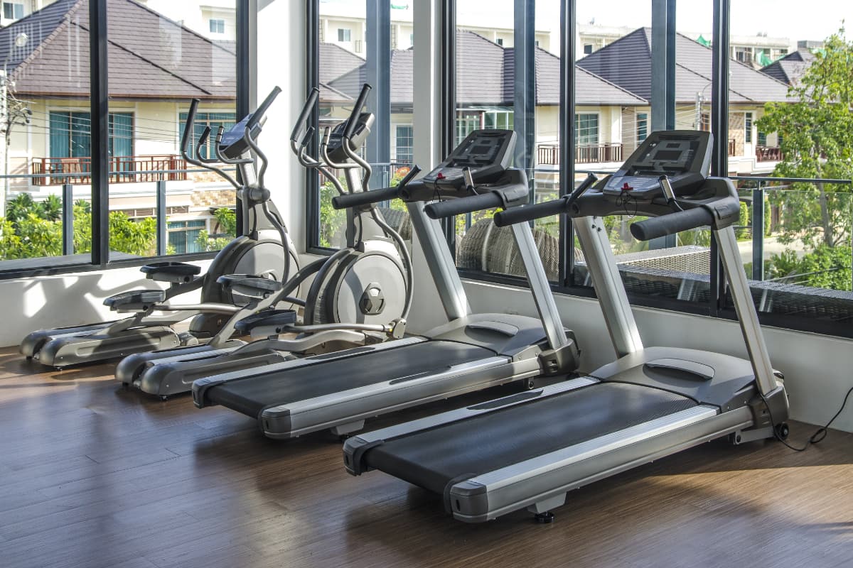 apartment complex gym with two ellipticals and two treadmills