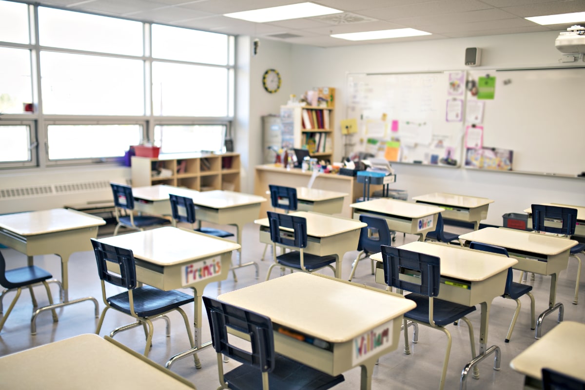 school classroom with rows of desks and whiteboard